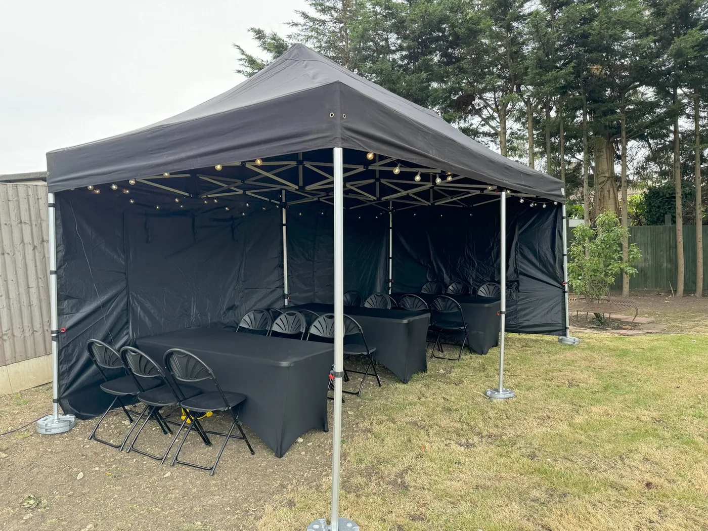3x4.5m gazebo hire dressed with lights and furniture at a private garden event